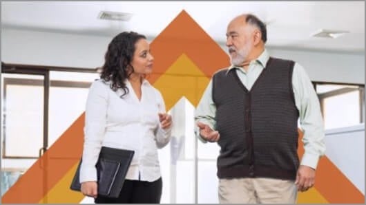 Man and woman standing and speaking with one another