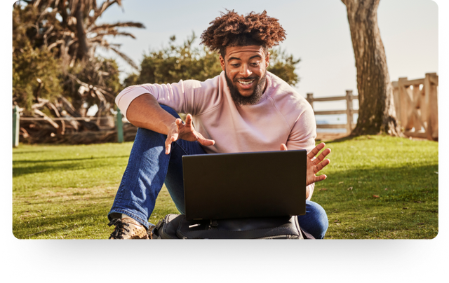 photo of a person working on a laptop at a park