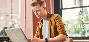 photo of a person studying on a laptop
