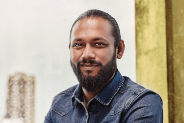 Man in a blue shirt looking towards the camera
