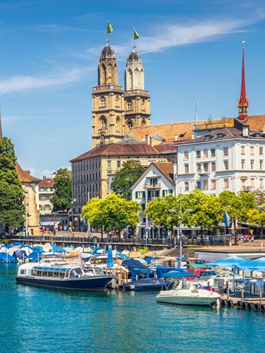 Buildings and boats on a river in Switzerland