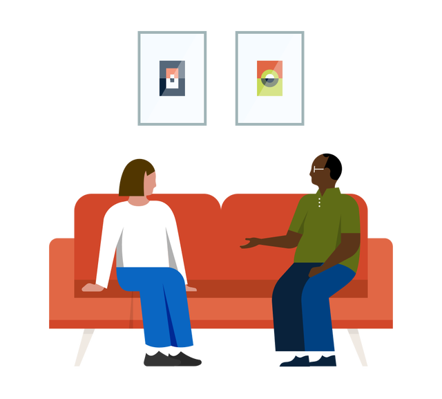 Two people in a discussion sitting on the couch