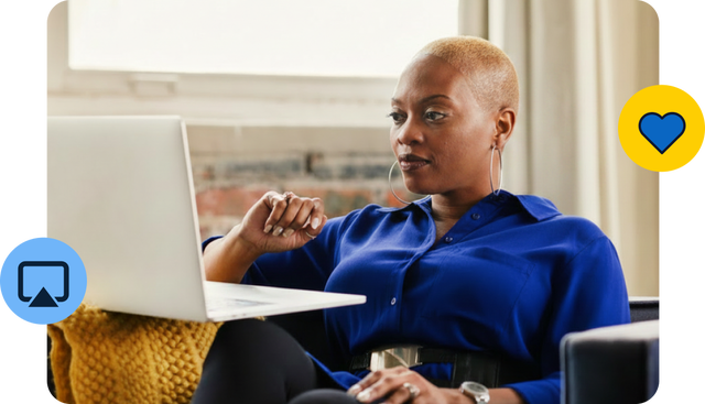 Woman working on laptop in bright room