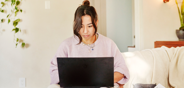 Photo of a woman working on a laptop