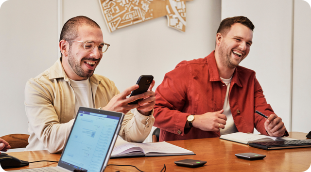 photo of Coworkers laughing together during casual meeting