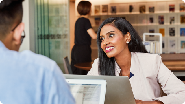 Smiling professional woman in office meeting