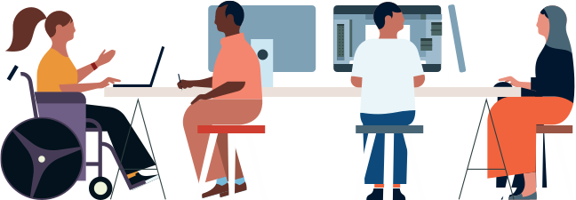 A group of workers in an office environment working on computers and laptops