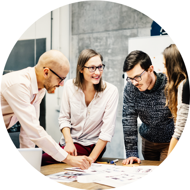 Image of 2 male and 2 female working professionals reviewing documents and discussing. 