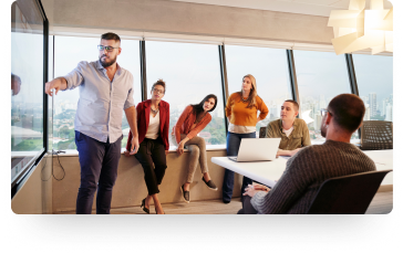 photo of several people in a conference room for a presentation 