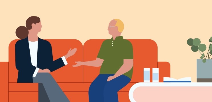 Two people in discussion on a couch