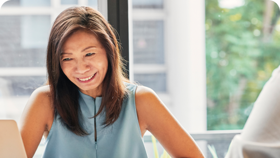 An individual smiling in an office.