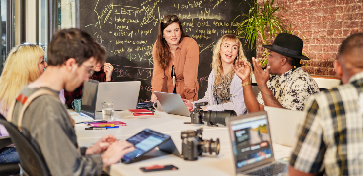 Stock photo of young adults standing together, used to represent City Year’s focus on developing young leaders.
