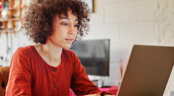 Image of a professional working on a laptop