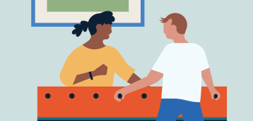 Two people playing foosball
