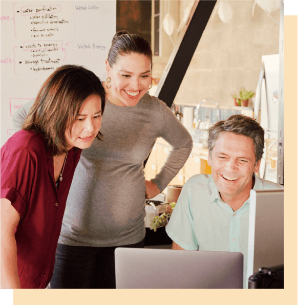 Image of people standing around a desk working
