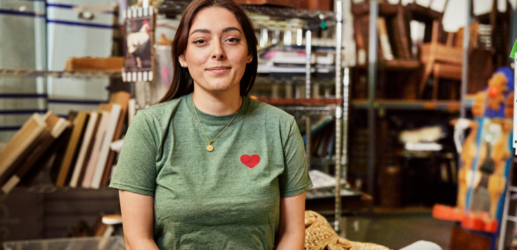 Woman smiling in a warehouse.
