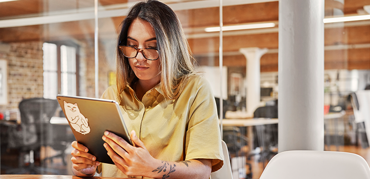 A cool woman working on a tablet