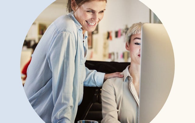 image of two professionals looking at a monitor