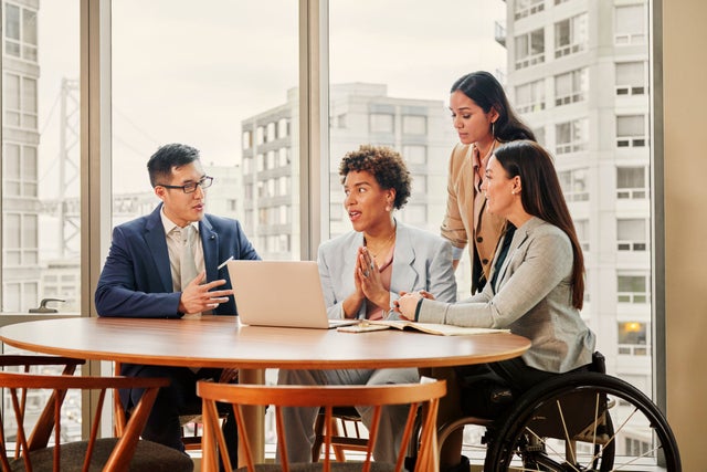 Group of 4 people in an office environment