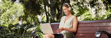Professional female working from a park bench