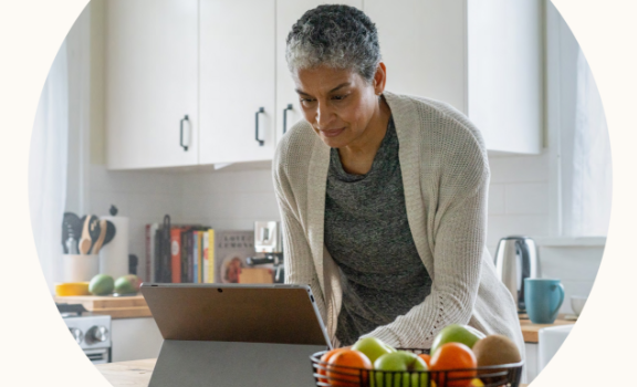 Image of woman working from home looking at her laptop