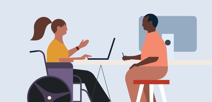 A person in a wheelchair in conversation with another person