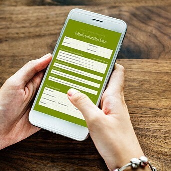 Female hands holding phone with initial evaluation form on the screen