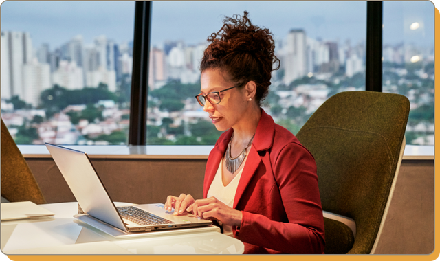 Professional woman working on laptop in office