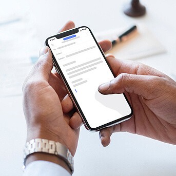 Male hands holding a phone with a message on the screen