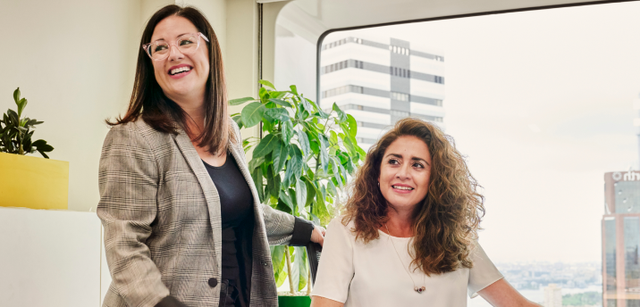 Photo of two women working in an office