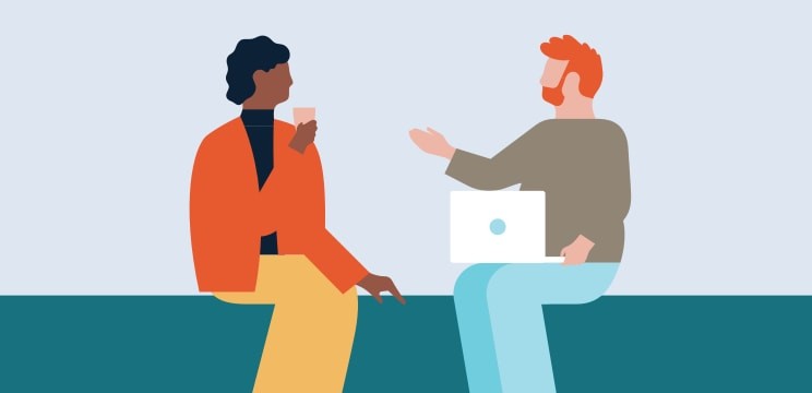 Two colleagues chatting on a bench