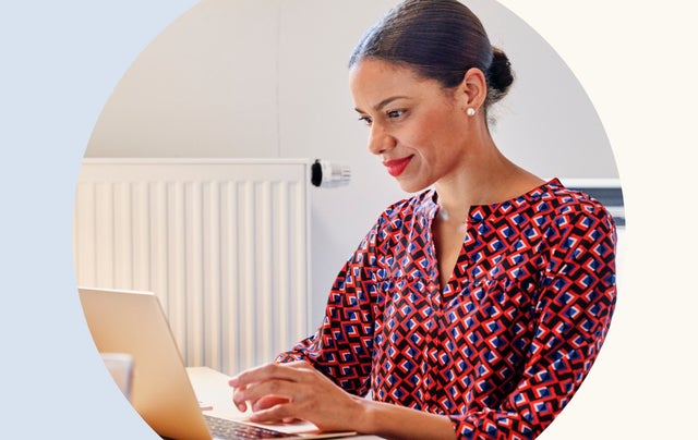 Woman, smiling, looking at her laptop