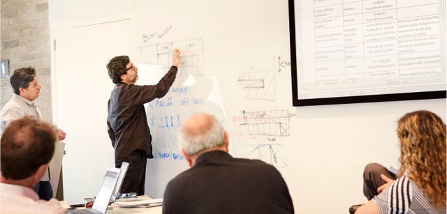 Image of two professionals smiling while collaborating