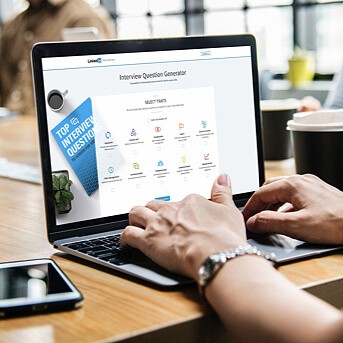 Male hands typing on computer with Interview Question Generator on the screen