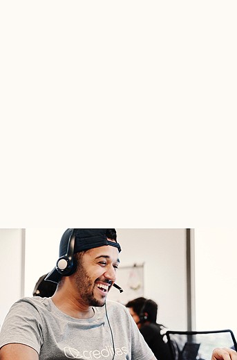 Photograph of a male with a headset smiling off screen