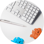 grey keyboard and pen on a white desk