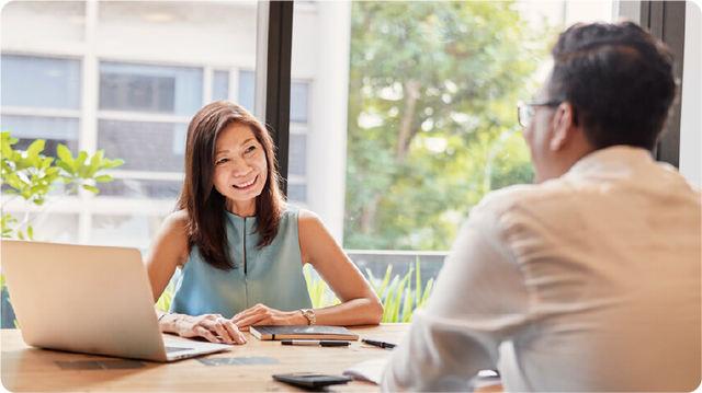 Smiling businesswoman meeting colleague in office