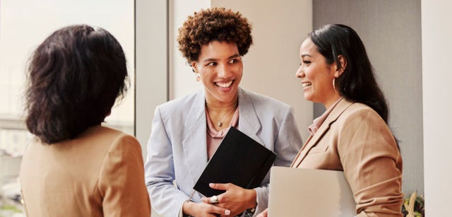 Image of three professionals having a conversation