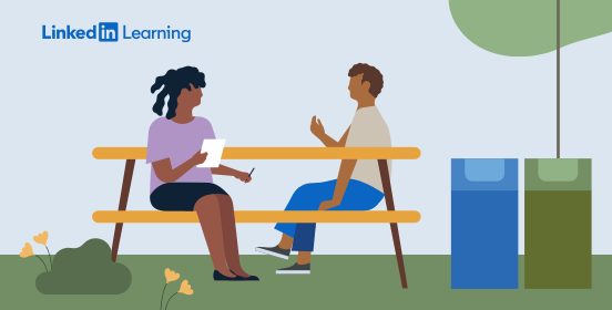 woman and man sitting at a table outside discussing recycling