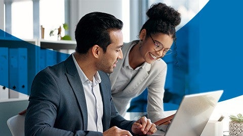 Image of two people looking at  laptop