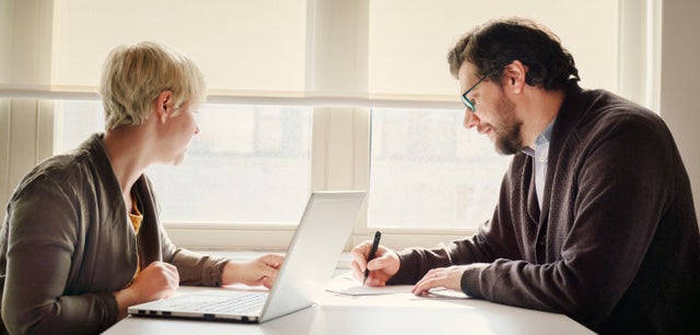 Image of two professionals collaborating at a desk