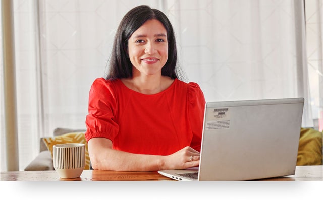 Image of smiling professional working on a laptop