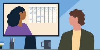 A man sitting at his computer and speaking to coworkers in a video meeting