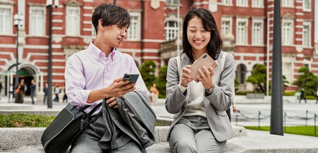 two people checking data on their smart phones
