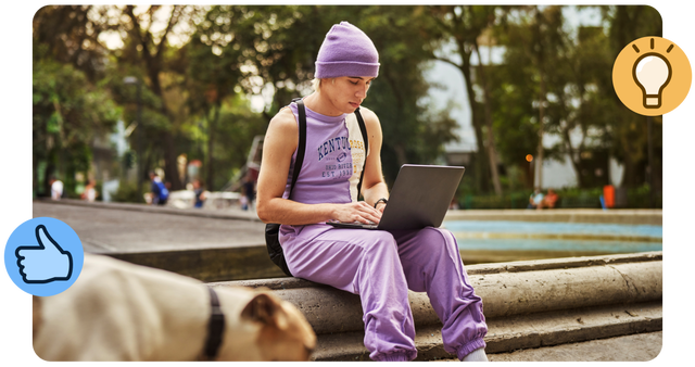 Young person working on laptop outdoors