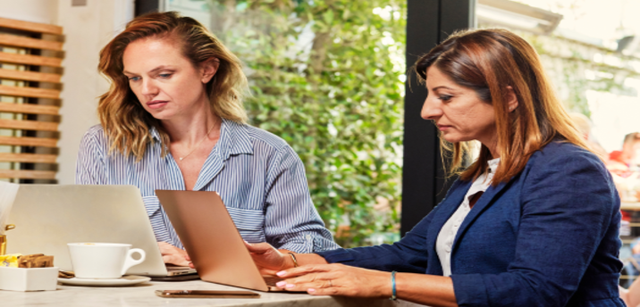 two people working on laptops
