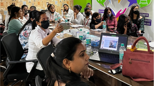 Image of numerous professionals in a conference room
