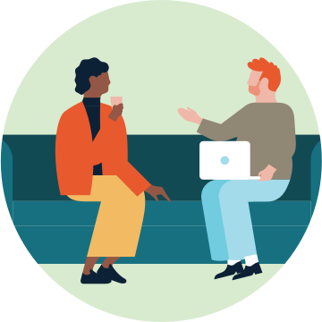 Two colleagues sitting on a sofa in conversation