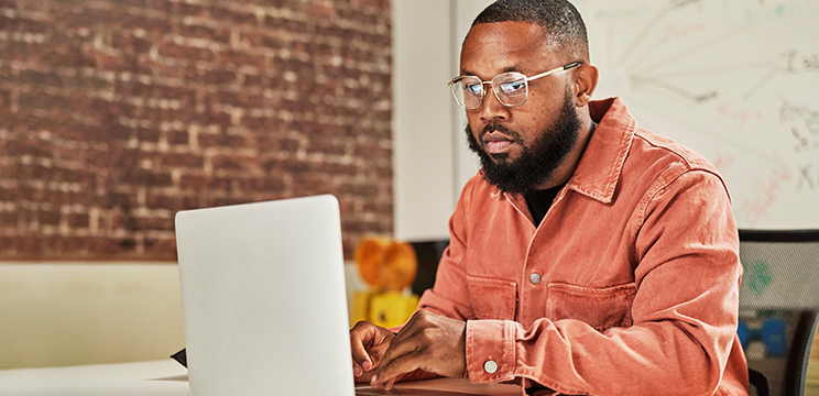 A man reads a message on his laptop.