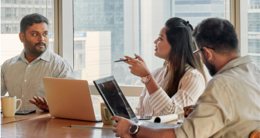 Image of professionals having a conversation in a conference room